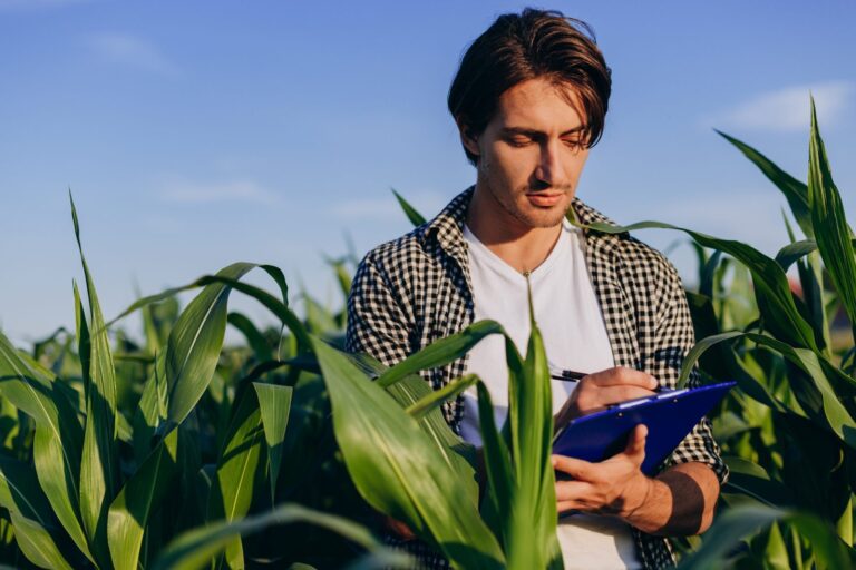 young-agronomist-in-a-field-taking-control-of-th-2022-12-16-11-32-35-utc-scaled